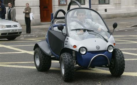 Noel Edmonds driving a small QPOD city car